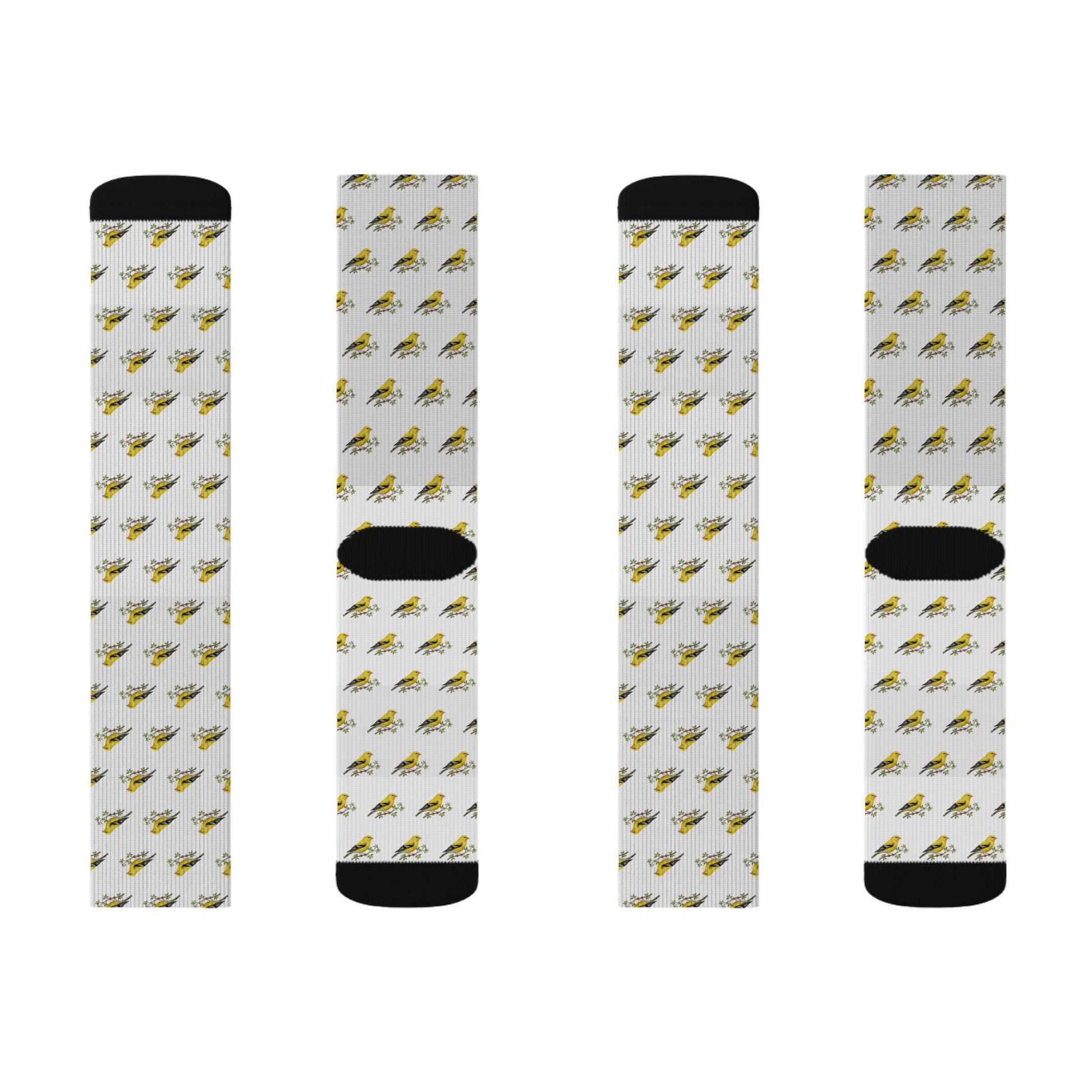 Four socks with a pattern of small yellow birds on a white background