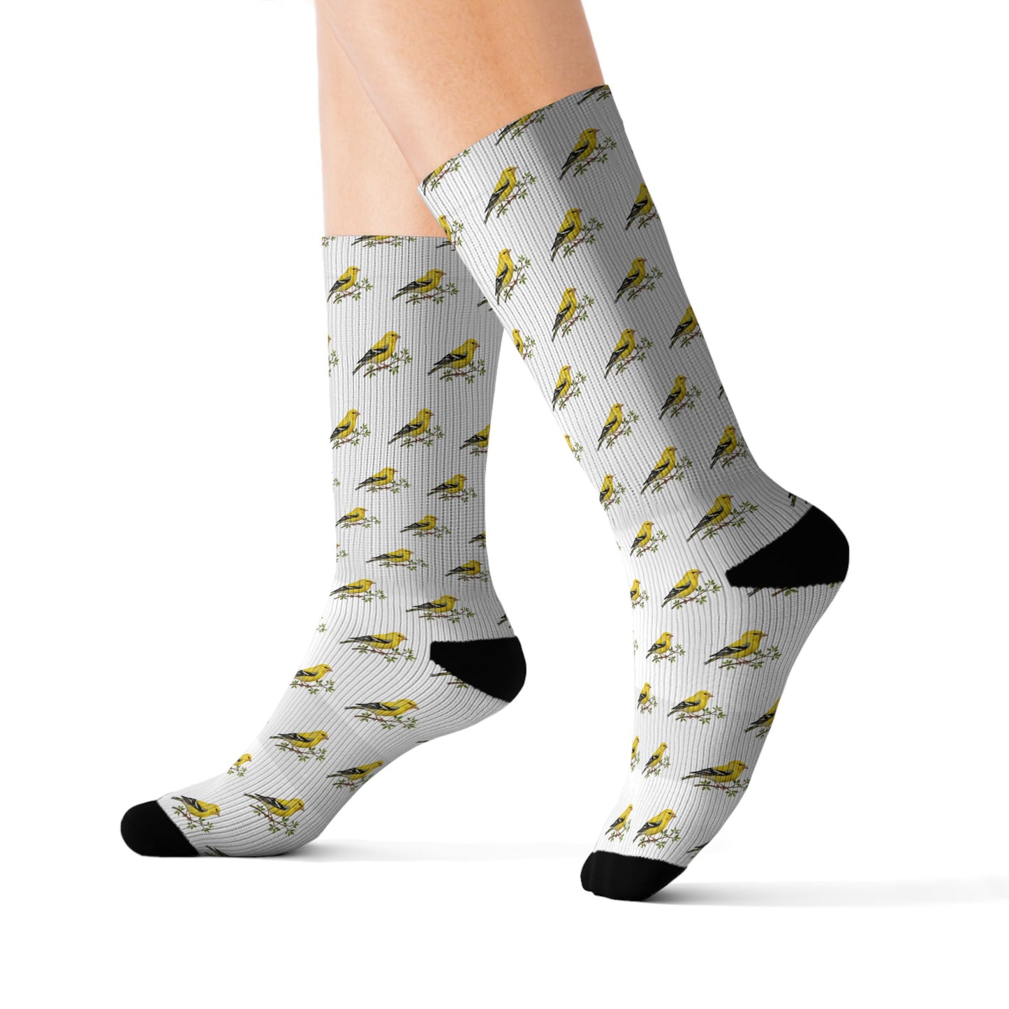 Socks with bird pattern worn by a person on a white background
