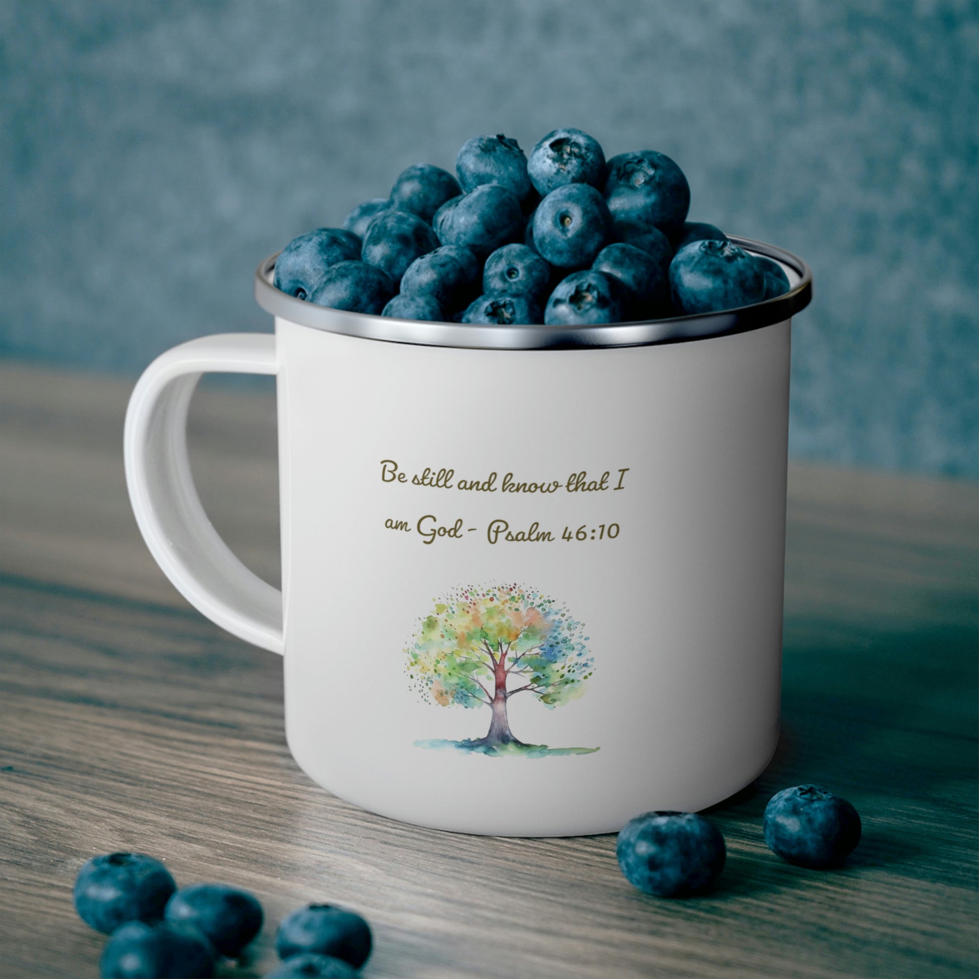 Be still and know camping mug filled with blueberries