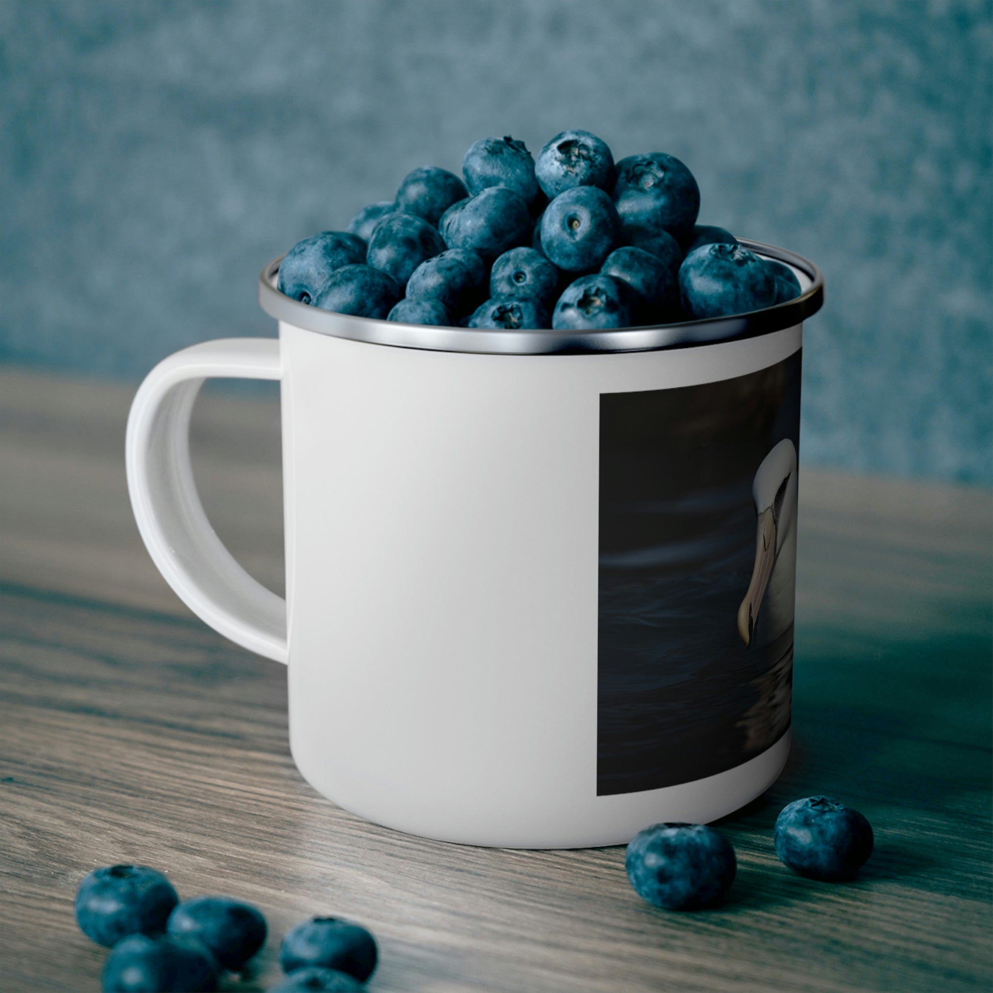 albatross camping mug filled with blueberries